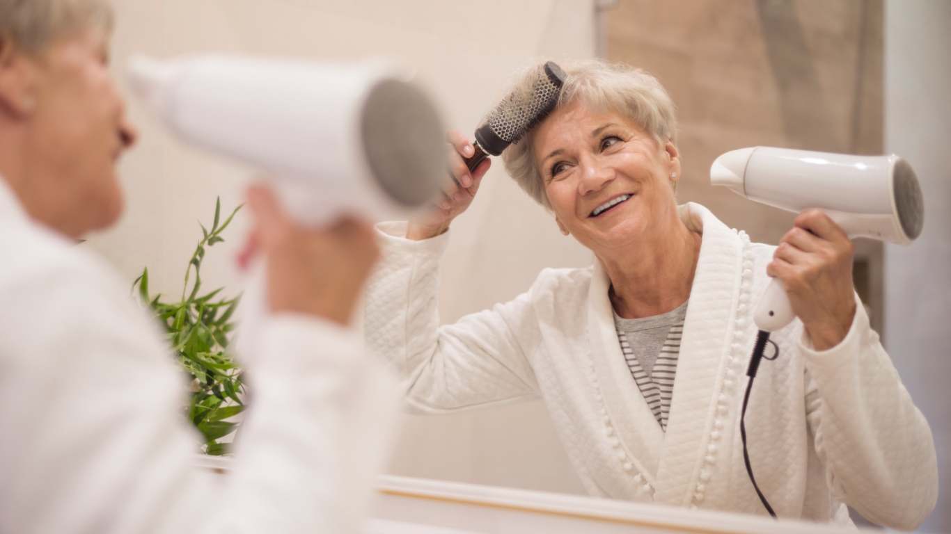 imagem de uma senhora cuidando do cabelo na menopausa